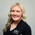 Business health partners employee portrait, professional woman in branded BHHP polo shirt, healthcare business, corporate staff, friendly professional, health industry, team member image.
