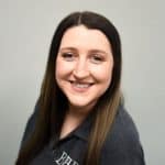 Professional woman smiling, representing Business Health Partners' corporate wellness and healthcare solutions.