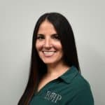 Professional woman wearing a business health partners uniform, smiling confidently.