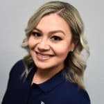Business health partners employee portrait, professional woman in navy polo with company logo, healthcare and business services emphasis, smiling confident workforce, corporate health support, team-focused environment.